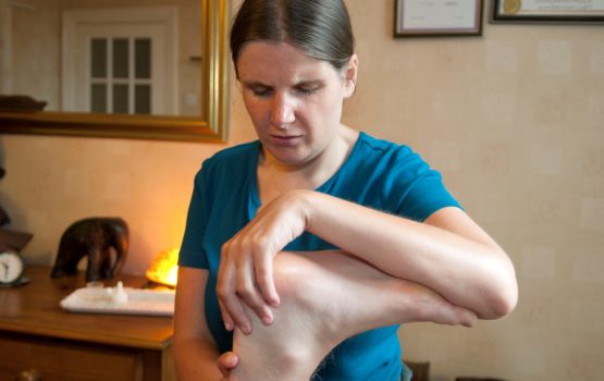 A foot massage treatment in progress by SB Holistic